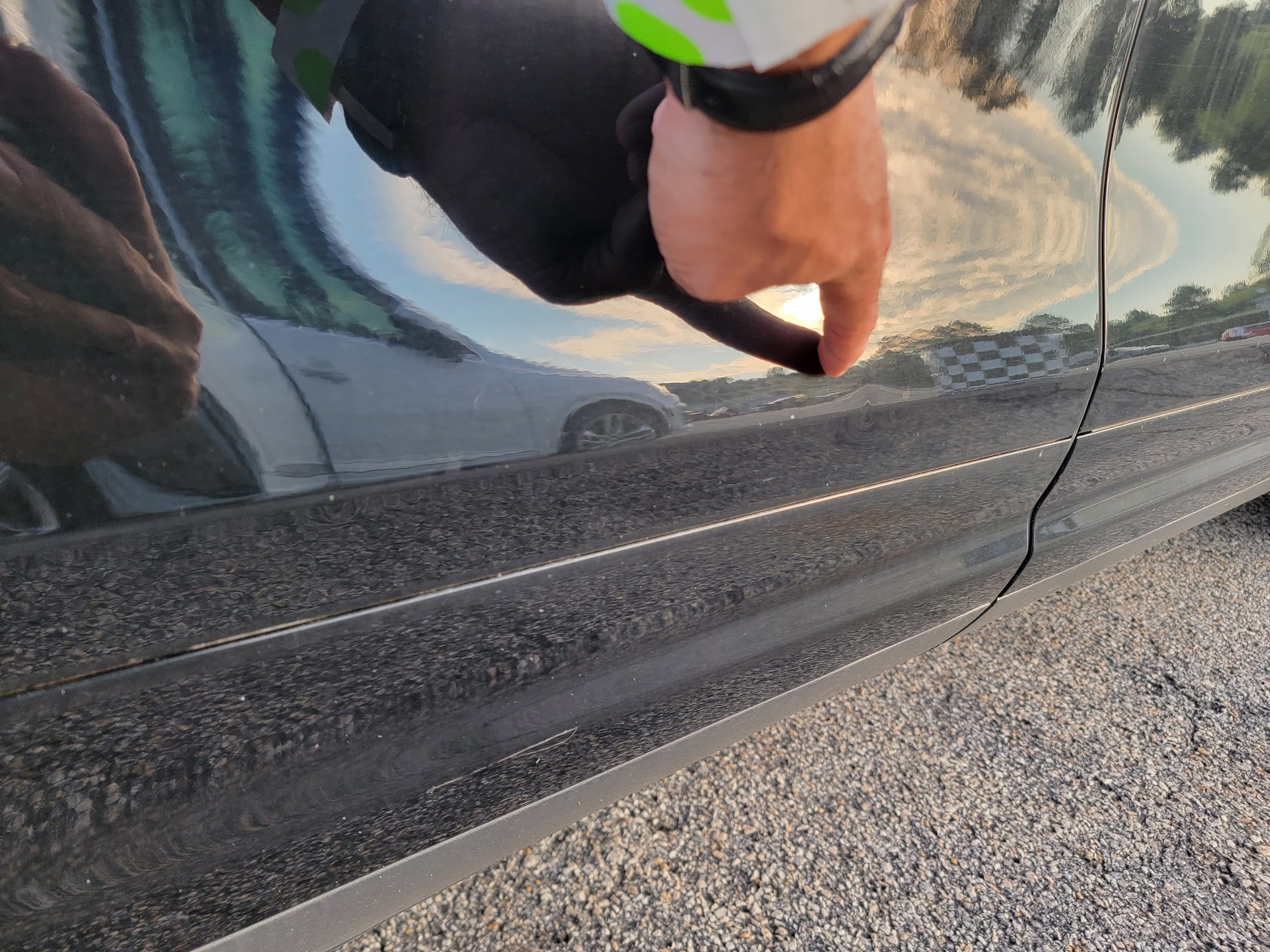 Inspector pointing at body panel damage