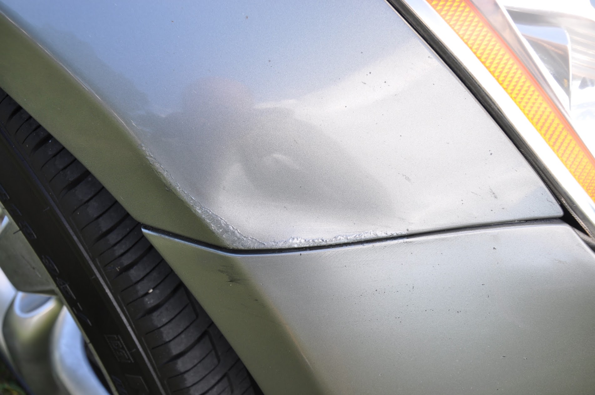 Close-up of vehicle bumper paint damage
