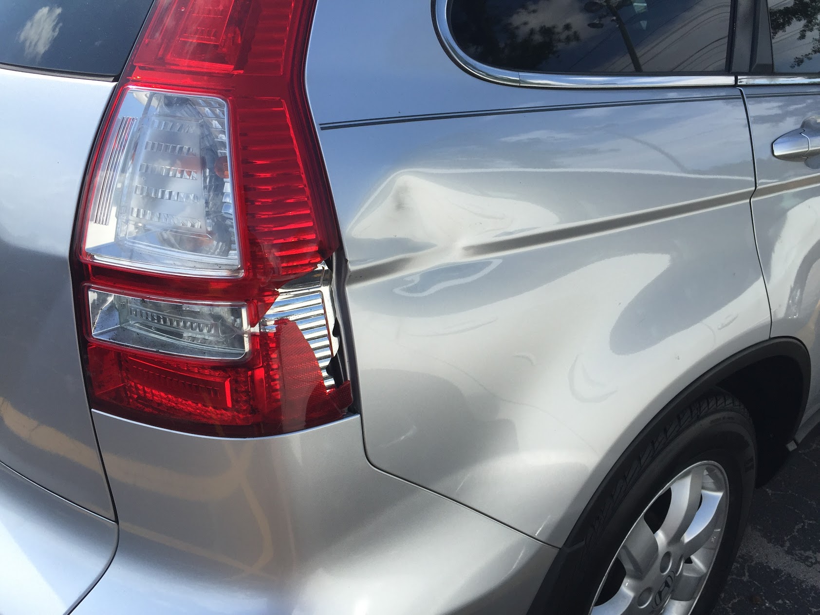 Close-up of rear quarter panel body damage